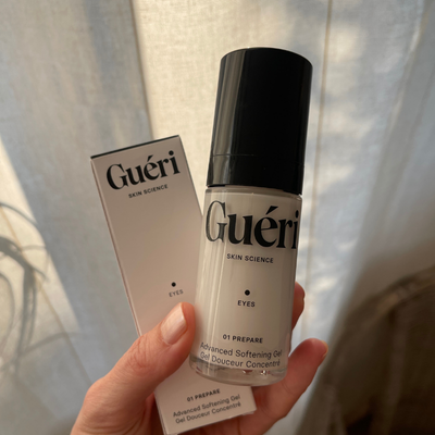 Product photography of Gueri eye cream in an aesthetic skincare setting.