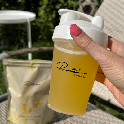 Product photography of Clear Whey protein from Protein.dk in an aesthetic fitness and wellness setting.