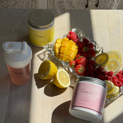 Product photography of Gut Repair supplement from Protein.dk in an aesthetic wellness setting.